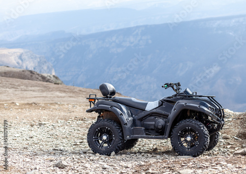 ATV Quad Bike in front of mountains landscape. Skiing and outdoor recreation in the mountains.