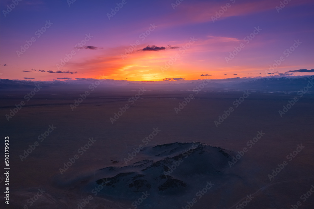 Beautiful panoramic aerial view landscape of snow mountain Altai sunset above clouds