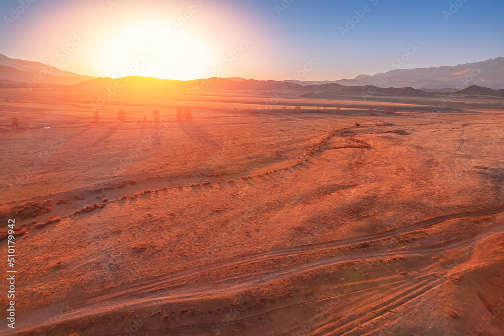 Naklejka premium Altai Kurai steppe Russia, beautiful landscape autumn forest with snow peaks mountains Chuysky tract. Aerial top view