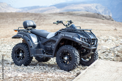 ATV Quad Bike in front of mountains landscape. Skiing and outdoor recreation in the mountains.