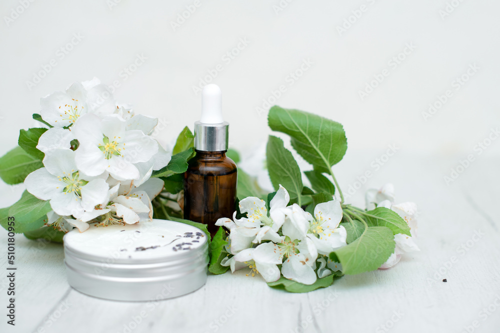 Natural beauty anti-aging products for face and hand skin care for women with sunscreen with fresh apple blossoms. Advertising of spring and summer cosmetics. natural cosmetics and aromatherapy. Natural beauty anti-aging products for face and hand skin care for women with sunscreen with fresh apple blossoms. Advertising of spring and summer cosmetics. natural cosmetics and aromatherapy.