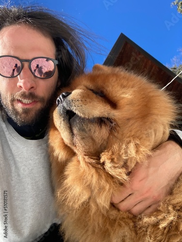 Selfie of a man and chow chow dog photo