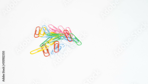 stationery colored paper clips on a white background with a place for text