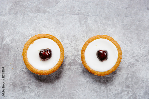 Cherry topped iced tarts photo