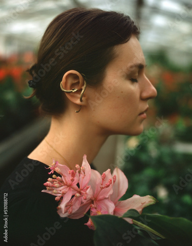 A dreamy portrait of a woman iwith pink flower photo
