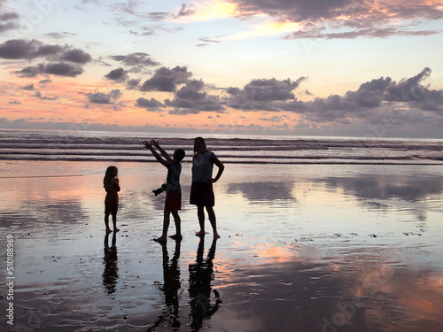 User-generated content family  beach taking camera pictures at sunset  photo