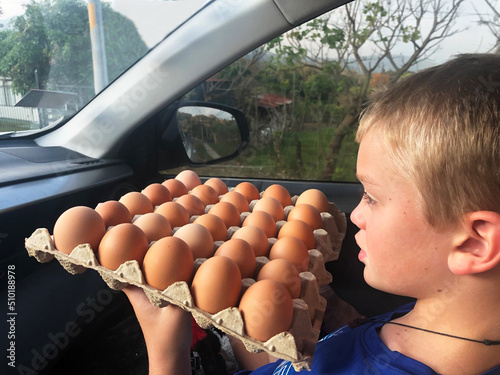 UGC Boy Carrying eggs in car that we bought at market 