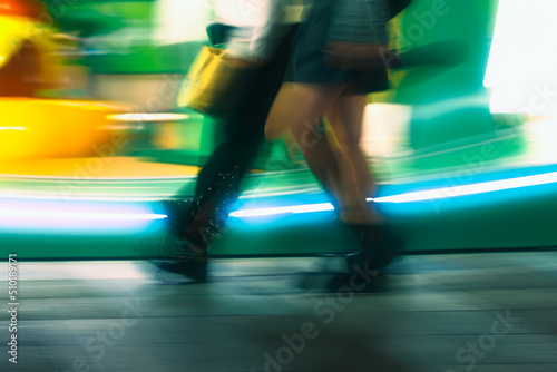 Passersby crossing zebra crossing at night