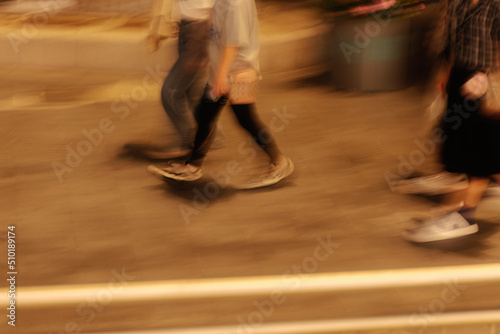 Passersby crossing zebra crossing at night photo