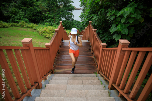 Fitness woman runner running on seaside boardwalk © lzf