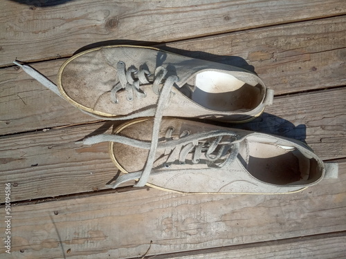old worn out and dirty white sneakers