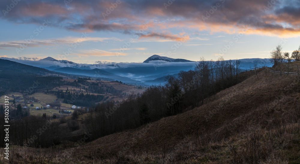Picturesque pre sunrise morning above late autumn mountain countryside. Ukraine, Carpathian Mountains, Hoverla and Petros tops in far.
