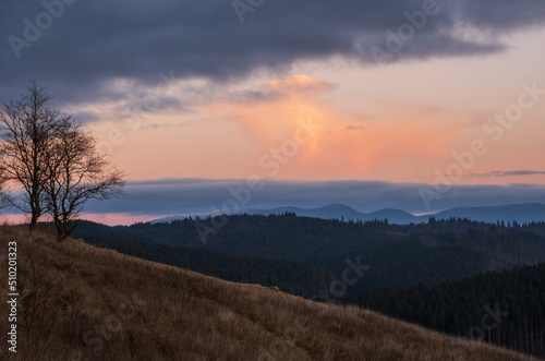 Picturesque pre sunrise morning above late autumn mountain countryside. Ukraine, Carpathian Mountains. Peaceful traveling, seasonal, nature and countryside beauty concept scene.