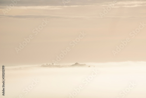Beautiful vibrant landscape image of sea of fog rolling across South Downs English countryside during Spring sunrise