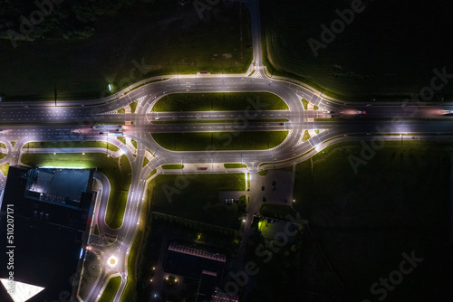 night over road junction, intersection road with cars with headlights on highway. night life in big city. looking down on traffic © hiv360