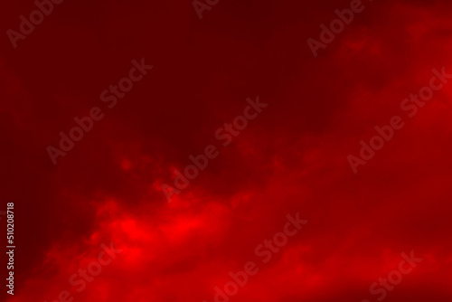 Red cloud texture background. Blurred photo of red sky with clouds. Photo can be used for galaxy space, New Year, Christmas and all celebrations backgrounds.