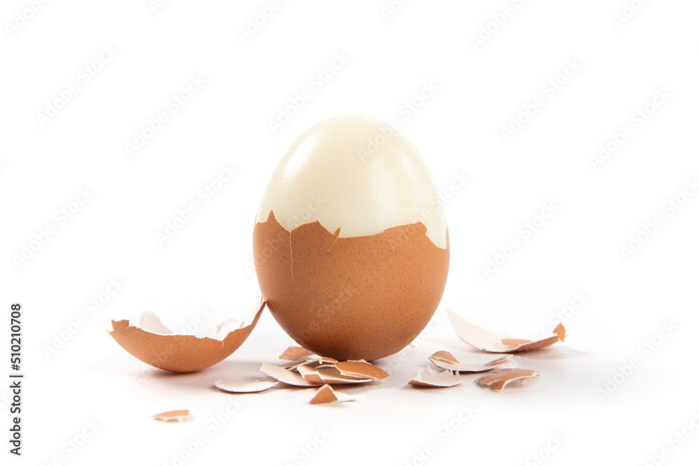 Peeled boiled egg with eggshell isolated on white background Peeled boiled egg with eggshell isolated on white background