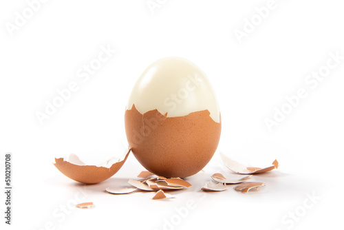 Peeled boiled egg with eggshell isolated on white background