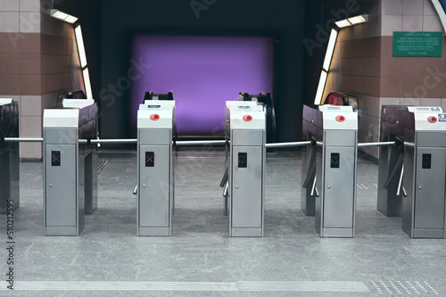 Many modern turnstiles outdoors. Fare collection system photo