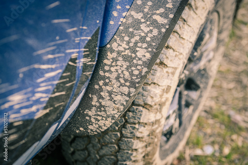 Close-up of a muddy wheel. Big tire of an off-road vehicle with mud. Splatters of mud on the side of the pick-up. Adventure  outdoor  4x4  extreme  travel  mountain excursion concept. Vehicle off road