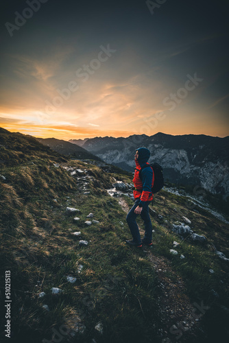 Man on Mountain Peak during Sunset in Summer - Hiker with Backpack in the austrian alps
