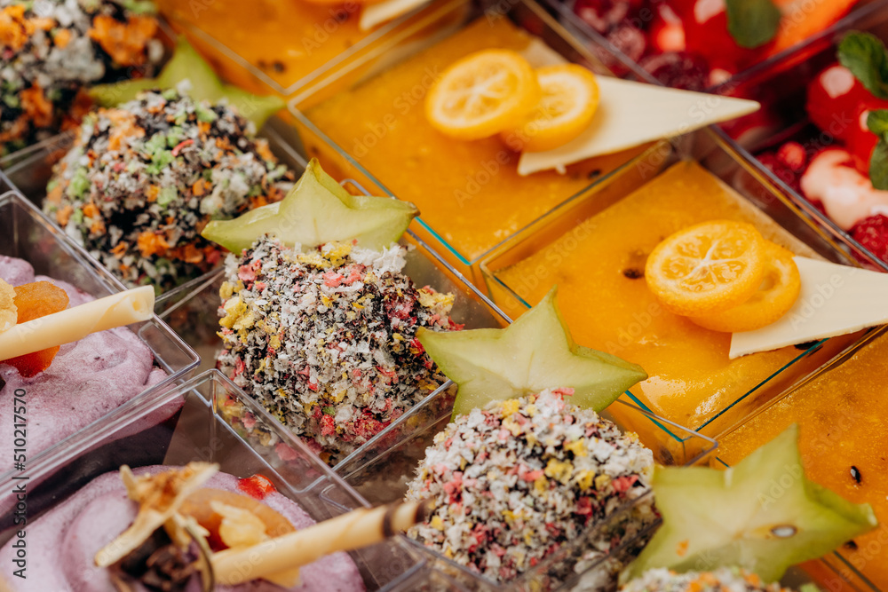 Fototapeta premium Different portions of desserts with jelly and fruit in a box are ready for delivery