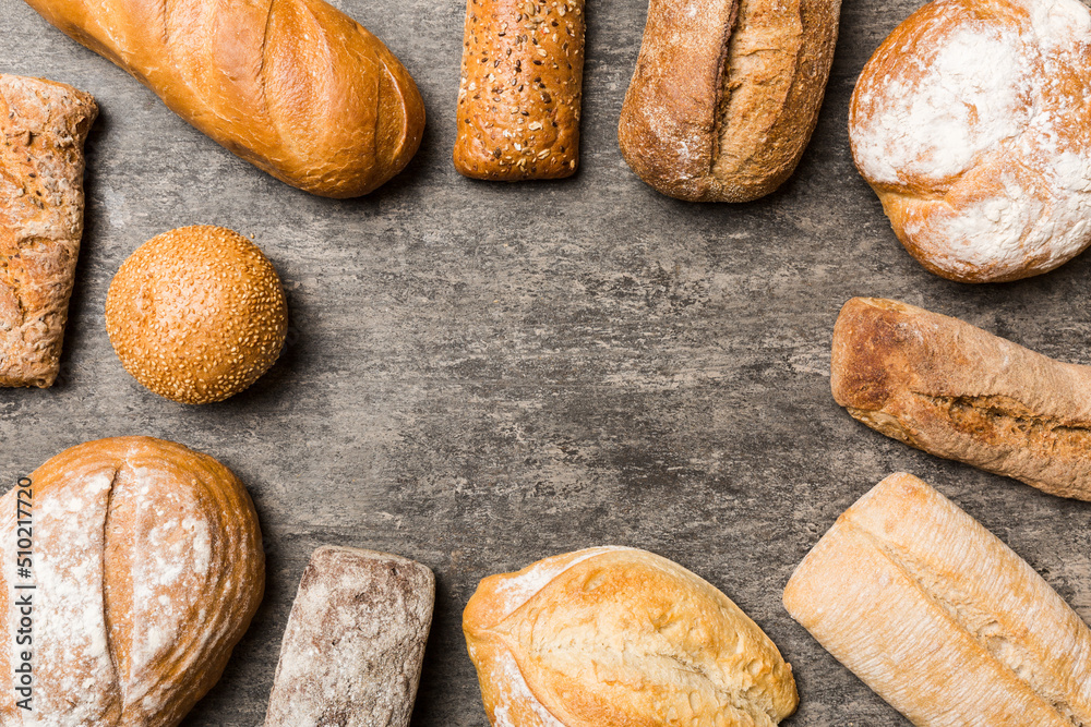 Homemade natural breads. Different kinds of fresh bread as background, top view with copy space