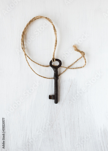 Old key on the wooden background. Art photo. © Sveta Mikhalevich