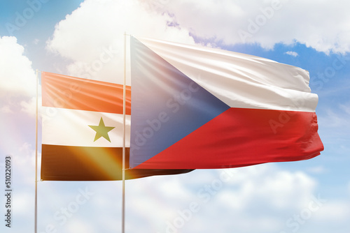 Sunny blue sky and flags of czechia and syria