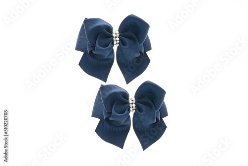 Blue satin bow for hair for girl, woman isolated on white background. Scrunchie hair clip accessory for girls and women. Close up
