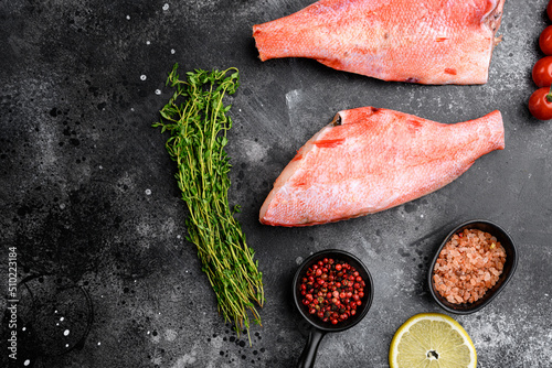 Fresh sea ocean red perch fish, on black dark stone table background, top view flat lay, with copy space for text