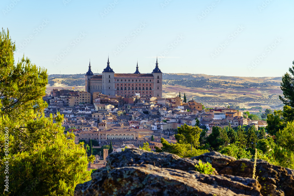 Alcalzar de Toledo surrounded by old buildings in the medieval city, Spain.