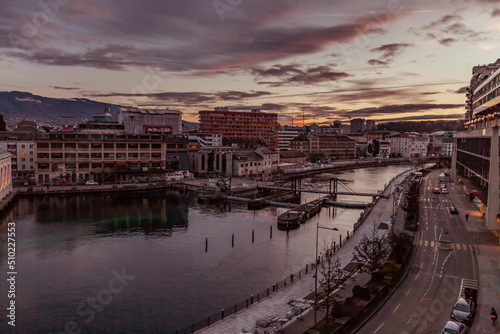 GENEVA, SWITZERLAND - February 20, 2022: Night traffice on Quai du Seujet street, North side of the Rhone channel.