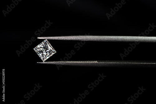 Princess cut diamond with tweezers