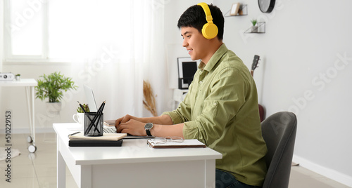 Young Asian man working on ...