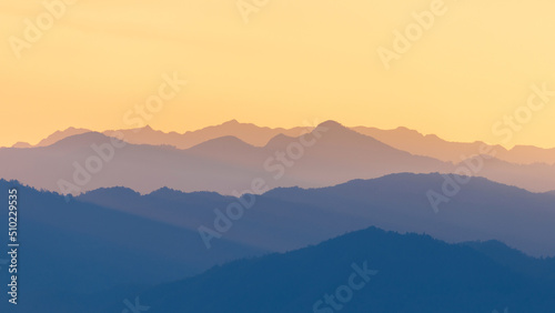 Colorful mountain range of tropical rainforest and sky at sunset.