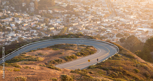 Photography Aerial view over curved road of Twin Peaks, San Francisco.