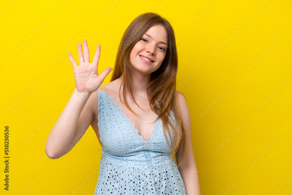 Young caucasian woman isolated on yellow background counting five with fingers Young caucasian woman isolated on yellow background counting five with fingers