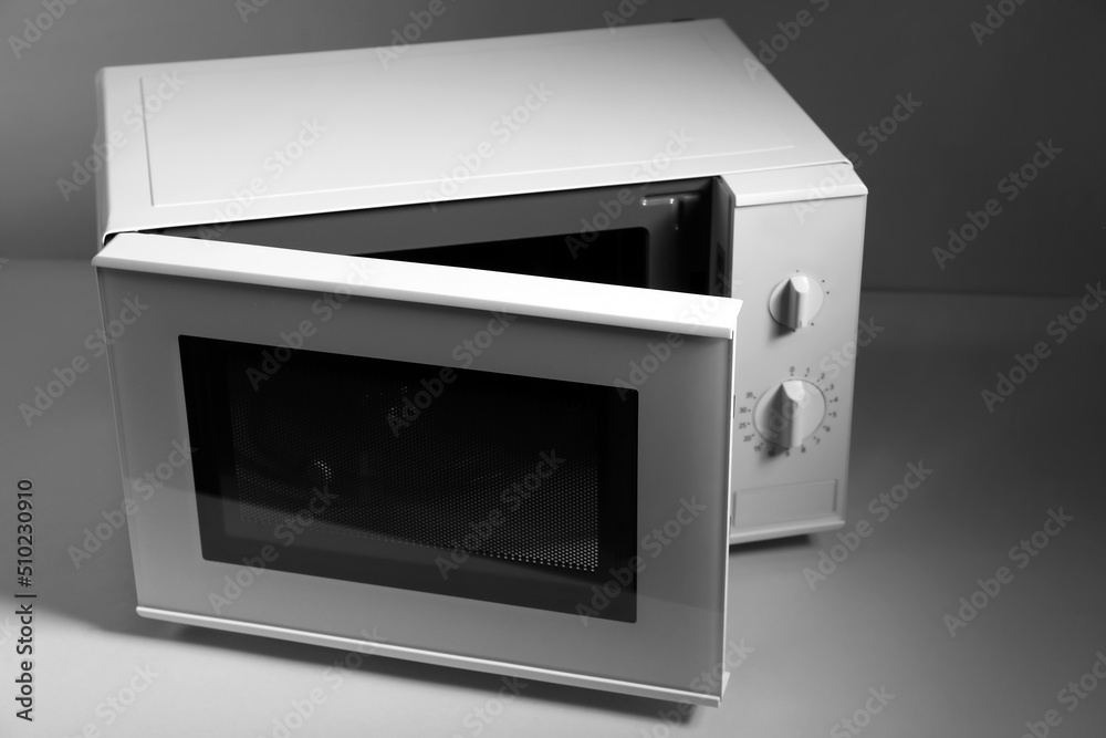 New modern microwave oven on light background New modern microwave oven on light background