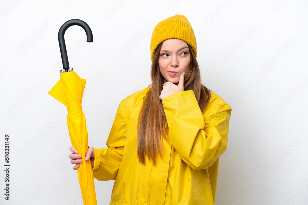 Young caucasian woman with rainproof coat and umbrella isolated on white background having doubts and thinking Young caucasian woman with rainproof coat and umbrella isolated on white background having doubts and thinking