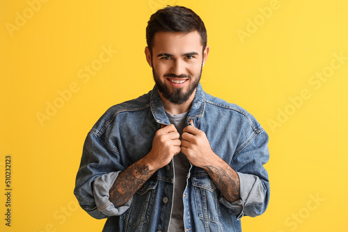 Smiling bearded man wearing...