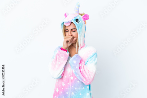 Blonde Uruguayan girl wearing a unicorn pajama isolated on white background is suffering with cough and feeling bad