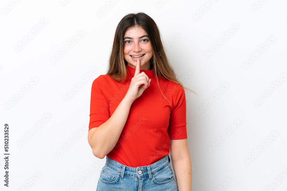 Young caucasian woman isolated on white background showing a sign of silence gesture putting finger in mouth Young caucasian woman isolated on white background showing a sign of silence gesture putting finger in mouth