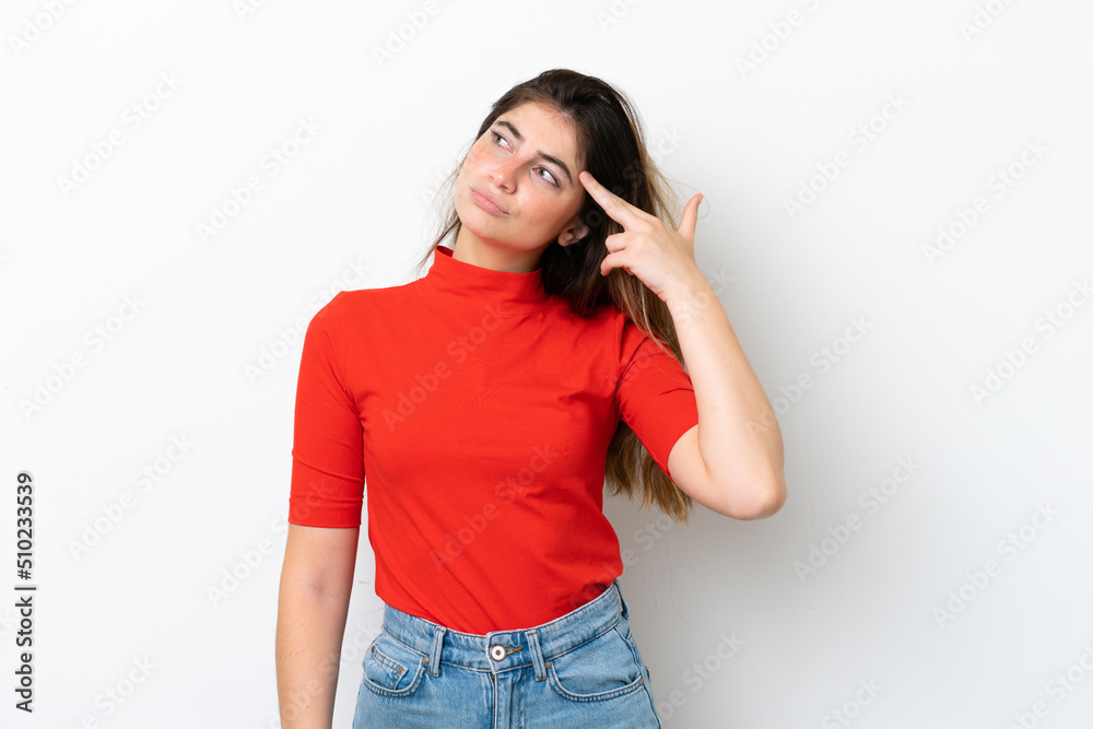 Young caucasian woman isolated on white background with problems making suicide gesture Young caucasian woman isolated on white background with problems making suicide gesture