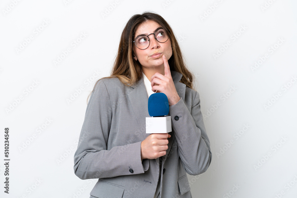Young caucasian TV presenter woman isolated on white background having doubts while looking up Young caucasian TV presenter woman isolated on white background having doubts while looking up