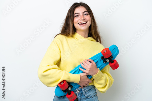 Young caucasian woman isolated on white background with a skate with happy expression