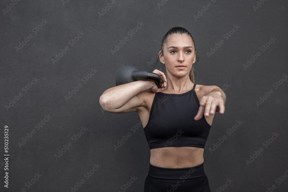 Determined sportswoman exercising with kettlebell Determined sportswoman exercising with kettlebell