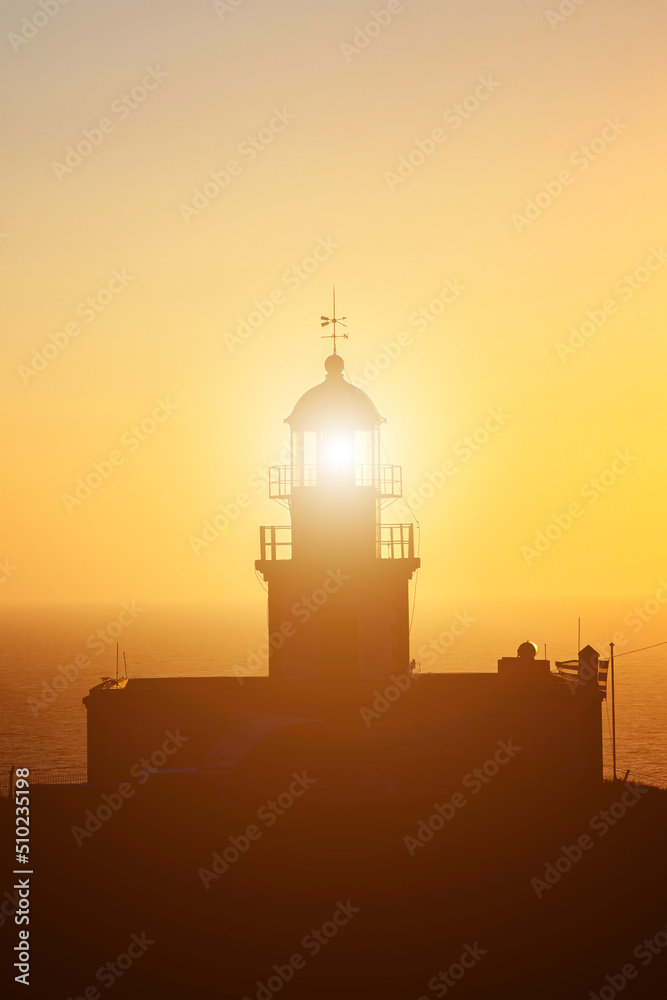 Silhouette of the lighthouse, beacon during sunset.
