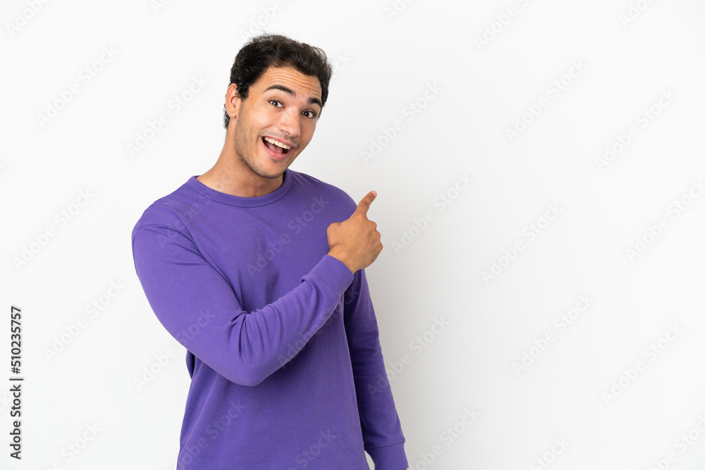 Caucasian handsome man over isolated white background surprised and pointing side Caucasian handsome man over isolated white background surprised and pointing side