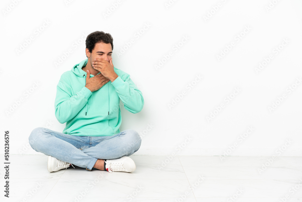 Caucasian handsome man sitting on the floor is suffering with cough and feeling bad Caucasian handsome man sitting on the floor is suffering with cough and feeling bad